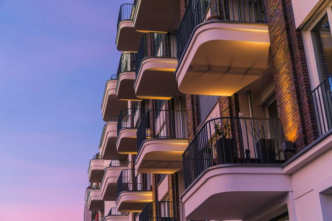 Residential building with balconies at sunset